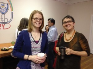 two women smiling with cups of coffee